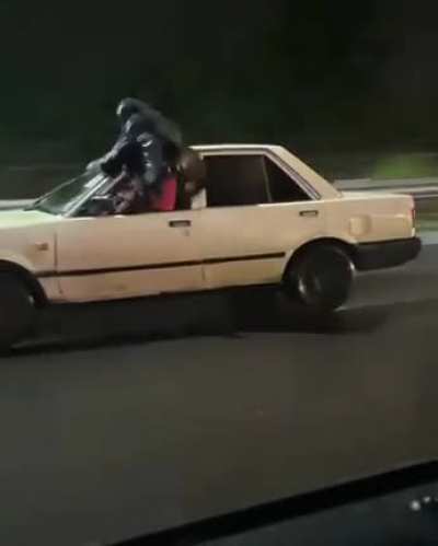 Human wiper at work on a Kenyan Highway.