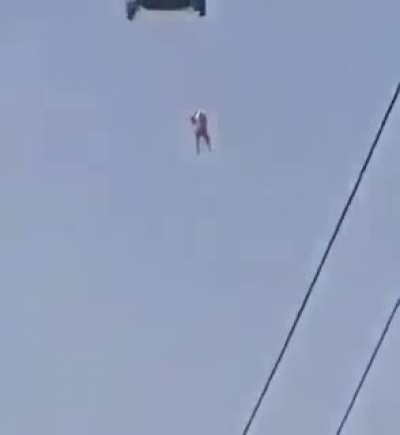 Taliban hang a person, presumed to be an American interpreter, from a U.S. Blackhawk helicopter.