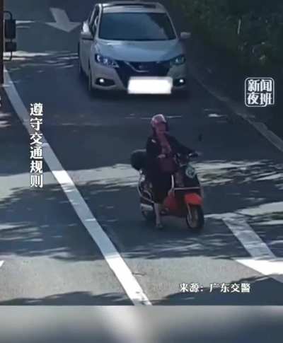 Driving a scooter like she owns the road