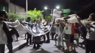 Brazilian protester accidentally knocks a policeman's cap off