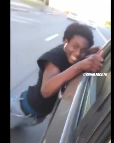 WCGW riding a skateboard while hanging on to a car.