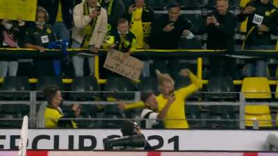 Kid holding a sign saying "Hi Erling, can I have your shirt? It's my birthday tomorrow. Lots of thanks" at the German Super Cup. Haaland goes into the stands to give the kid his shirt.