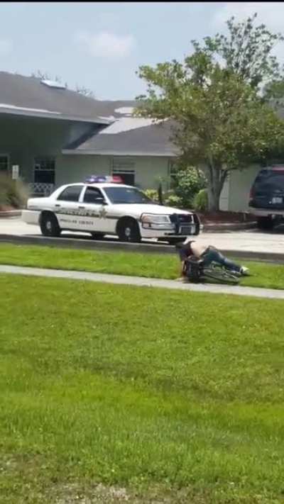 Cops driving on a sidewalk to deliberately ram a cyclist from behind