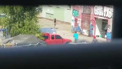 A couple showing up to homeless encampment in Seattle attempting to recover stolen items is attacked by mob, circles around the mob several times and runs over a man on the way out