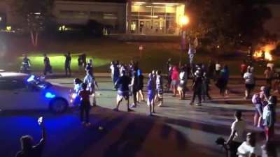After arsonists start multiple fires in South Caroline last night a single lone police officer tries to offer protection for firefighters to put them out. Protesters throw a rock at him