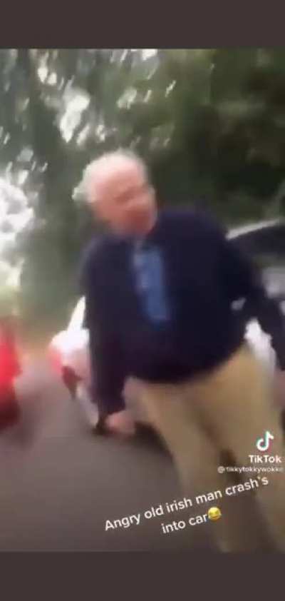 An angry old Irish man crashes in to another car and trades insults with a Londoner.