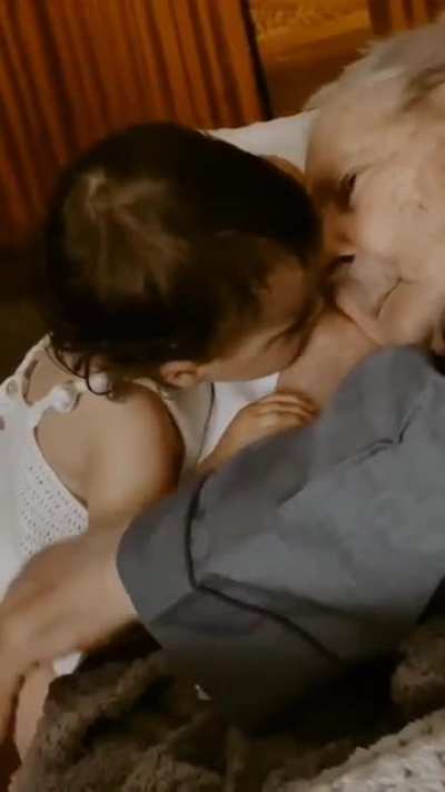 This granddaughter and grandfather who have 97 years between them share a moment together.