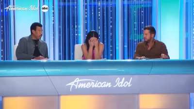 Katy Perry freaks out after American Idol contestant sings about losing friends in a school shooting.