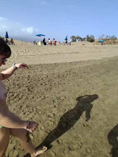 Strutting topless on the sunny beach