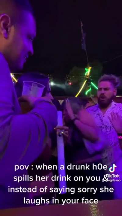 trashy woman gets a drink spilled from behind her, proceeds to freak out and do the exact same thing