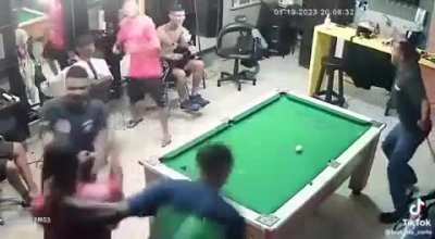 Some guys playing pool