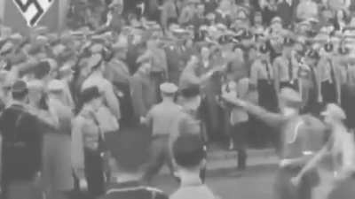 Father steps out of formation with son to hand the F&uuml;hrer a present