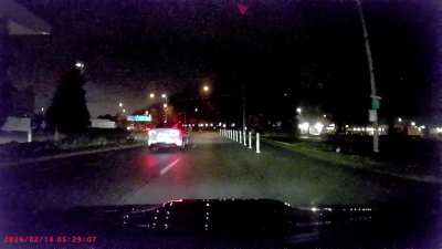 Black suv jumps over speed bump and later crashes into a parking a lot.