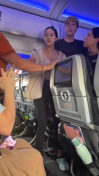 Woman attempts to open emergency exit on plane because her pilot boyfriend told her over the phone that a sound wasn&rsquo;t normal