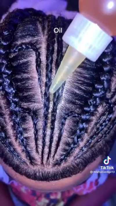 Braiding his hair