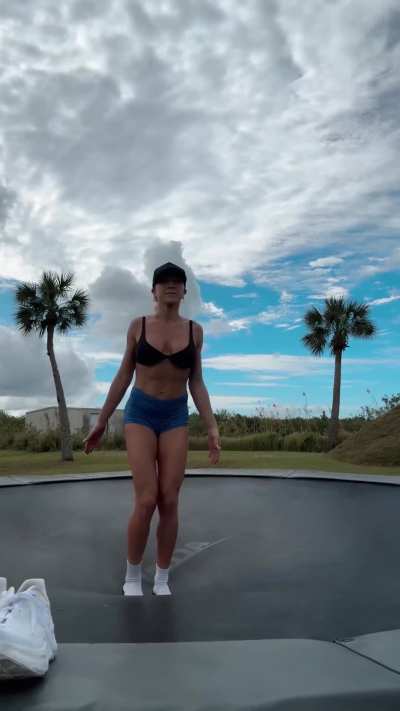 the athletic lady likes to jump on the trampoline.