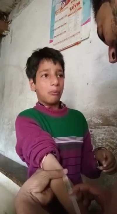 A young boy throwing tantrums while taking his vaccine shot