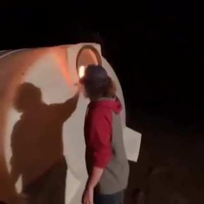 WCGW putting a flaming piece of wood into a mysterious container