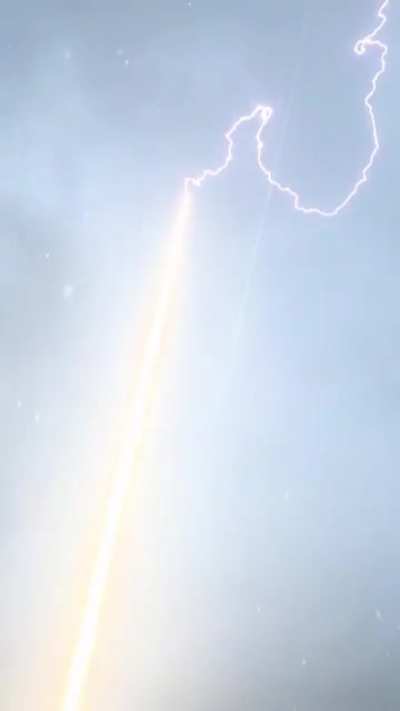 Lightning Bolt Is Guided To Ground Through Rocket Trail