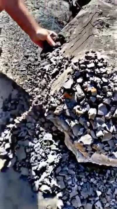 This stone effortlessly crumbling into smaller rocks