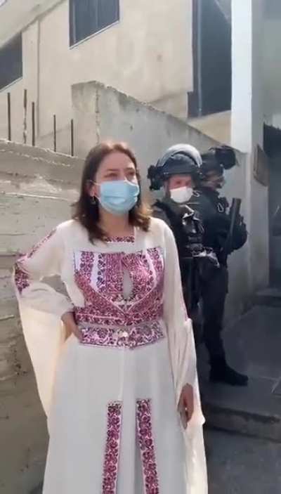 The Israeli Military arrest the head of a women's center and a fashion designer in a "raid on an exhibition of traditional Palestinian clothes and objects made by women".