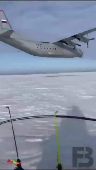 AN-12 doing a low pass, ice fisherman quite impressed