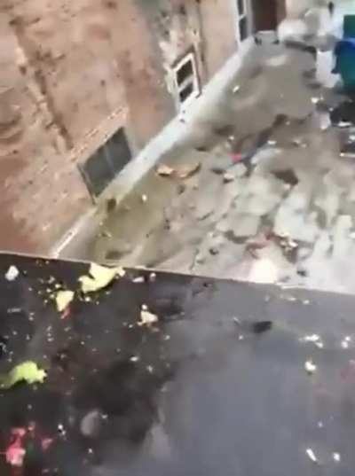 Man trying to break the bottle with a baseball bat.