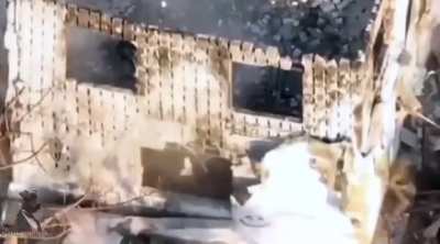 Soldier runs across street and throws a backpack bomb into a house