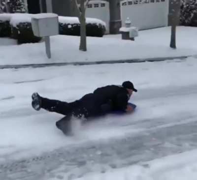 Someone called to complian about the kids sliding down the road so an officer joins them for the ride.