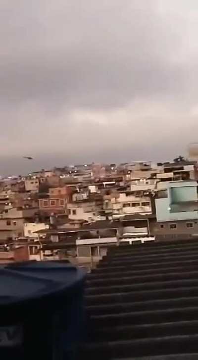 Brazil, Complexo do Alem&atilde;o, a favela in Rio de Janeiro, heavily armed criminal shoots at a police helicopter