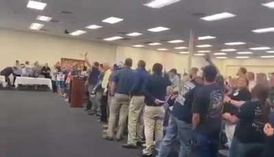During a Russell County school board meeting about trans equality, everyone but the people standing next to the wall broke out into hymns