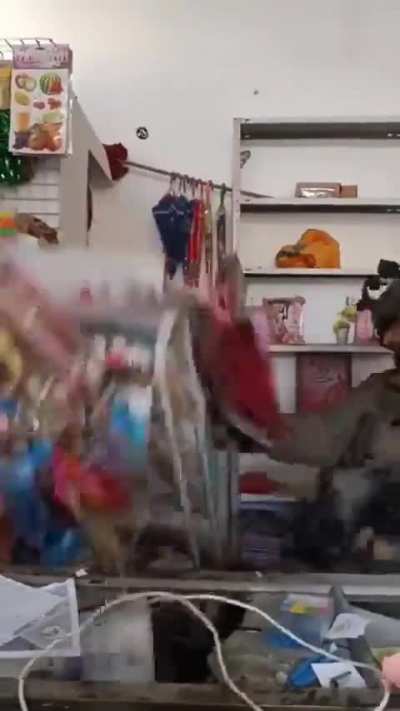IDF soldier mocks as he vandalizes a Palestinian shop smashing and destroying the store products in Jabalia Refugee Camp, north of Gaza City