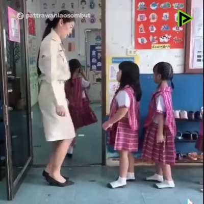 Schoolchildren in Thailand choose how they want to greet their teacher.