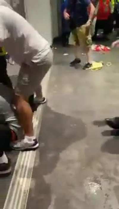 English football fans assaulting people, presumably because they got in without a ticket