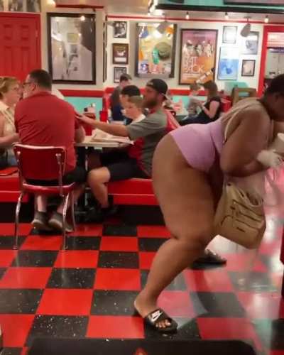 Woman twerks in front of family at restaurant