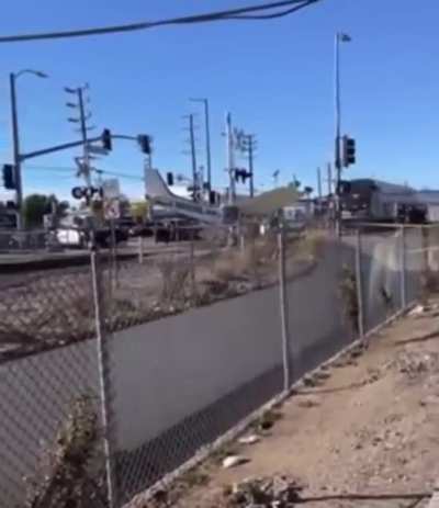 Crashed plane becomes unexpected participant in a train crash (pilot was pulled to safety just in time)