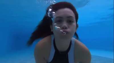 Nova swims and blows bubbles underwater