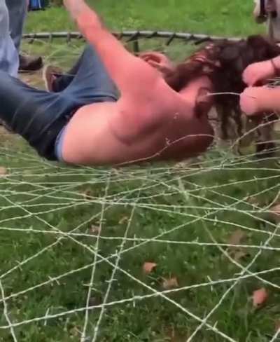 Man jumps onto trampoline of wire