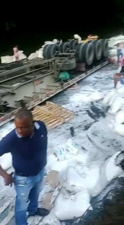 Aftermath of truck crash, people casually take the truck&rsquo;s contents