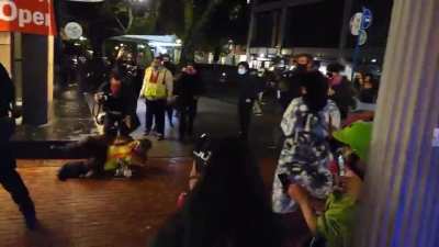 An officer aggressively shoved a protester to the ground when he was complying with their order.