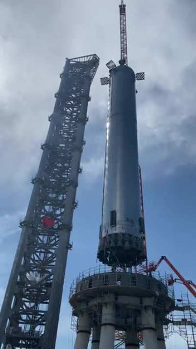 SpaceX&rsquo;s SuperHeavy Booster being hoisted onto the Orbital Launch Pad🚀