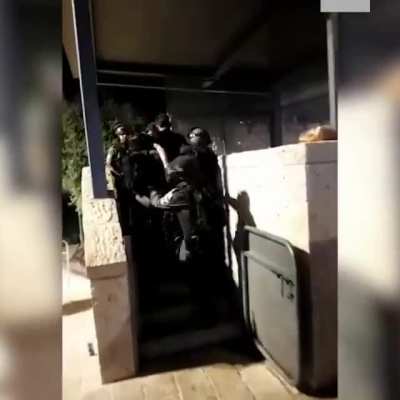 IDF soldier slaps a Palestinian man before being taken away by more soldiers