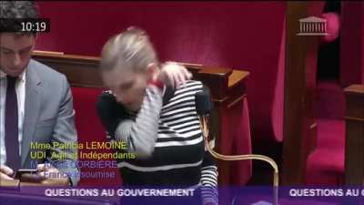The person standing behind France&rsquo;s Secretary of State for the Economy.