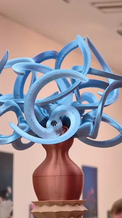 The Machinery of Enchantment II, William Darrell, 3d printed kinetic sculpture, 2025. Seems like it's zooming on but it's just going round.