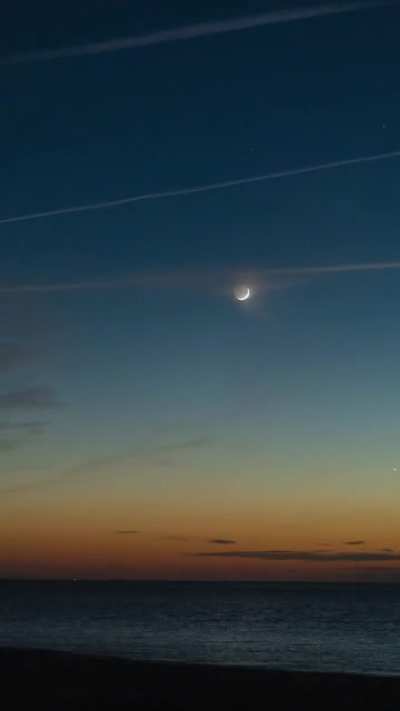 The moon and Venus setting over the Atlantic