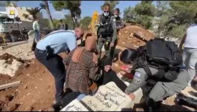 Israeli police separating a Palestinian mother from her child grave in a 16th century Palestinian graveyard to build a "Jewish Biblical Theme Park" ,😔 yet Israel dares to call me a terrorist for being born a Palestinan. I always ask myself. How is the wor