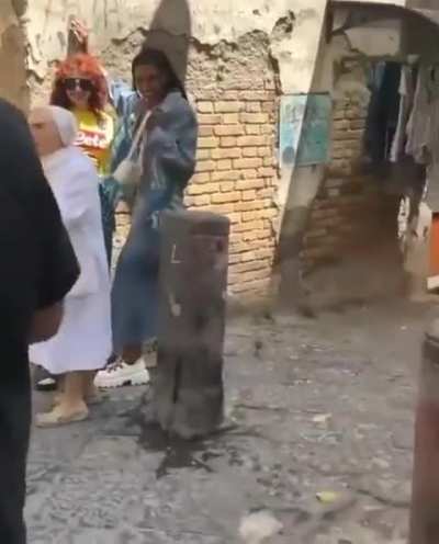 Nun freaks out after seing two women kissing on the street for a photo shoot.