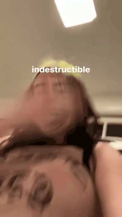 Smacking her boob