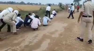 Guests attending a wedding in Bhind, MP, India made to do 'frog jumps' by cops for violating COVID-19 norms.