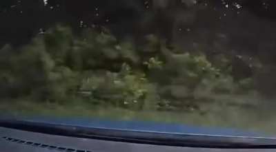 Car merges into cammers lane, and causes a rollover.